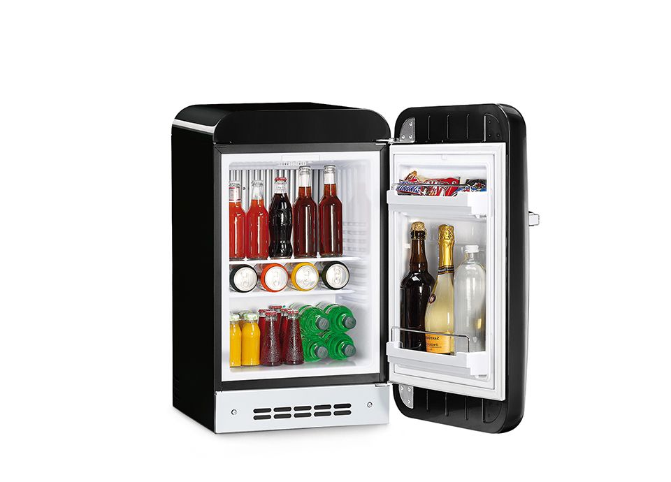 Open Smeg minibar with drinks inside, showing shelves and bottle holder