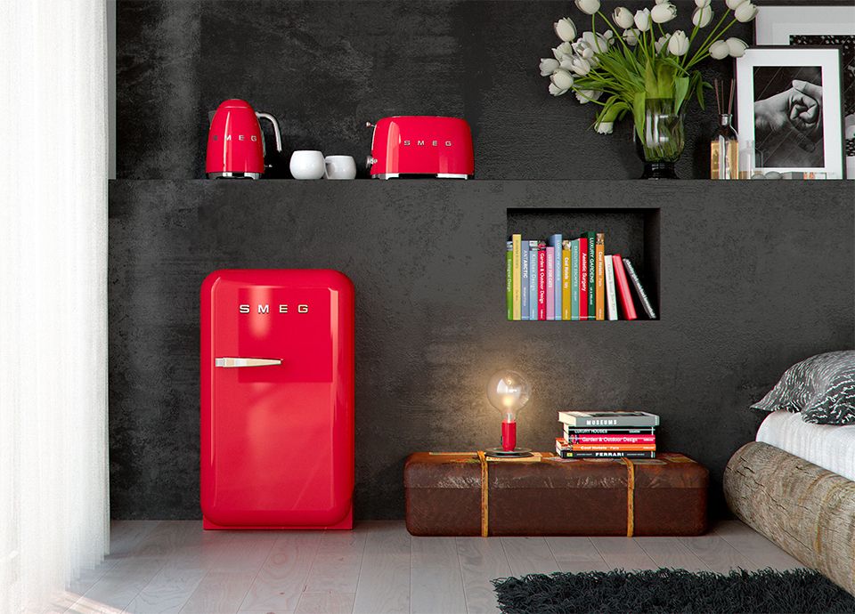 Red Smeg FAB5 minibar in a warm, stylish hospitality setting