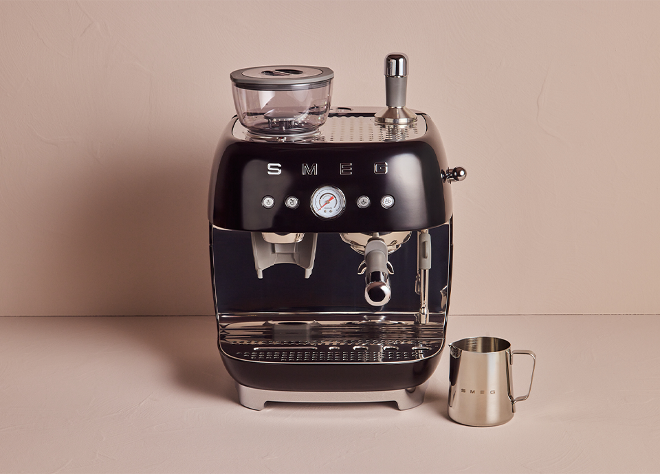 SMEG black gloss espresso coffee machine with grinder on pink background
