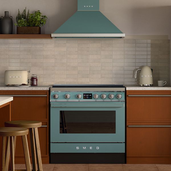 Smeg Portofino Freestanding Cooker in yellow with matching rangehood