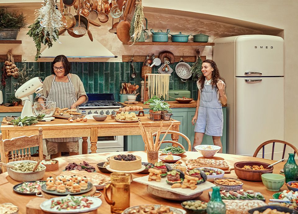 Busy Kitchen with lots of food and a Grandmother and Grand-daughter