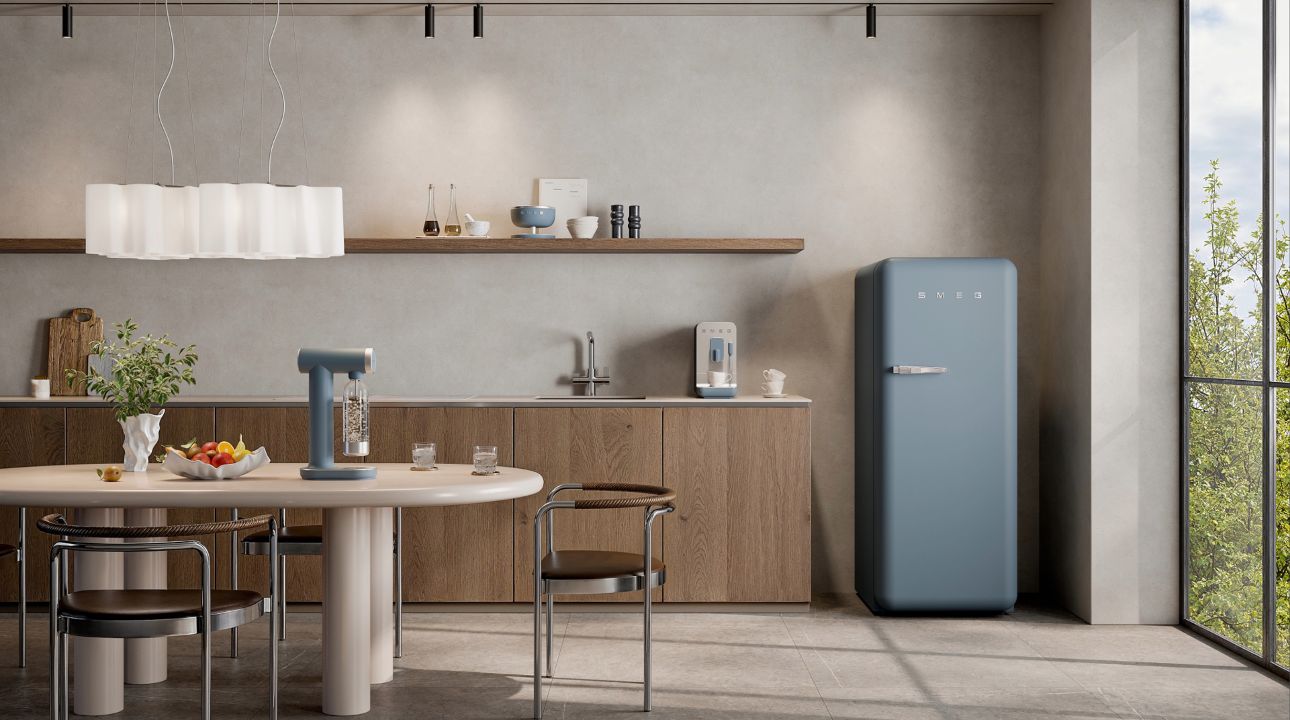 Modern kitchen with SMEG appliances storm blue matt finish, including fridge, soda maker and scale and coffee machine, set in a bright space