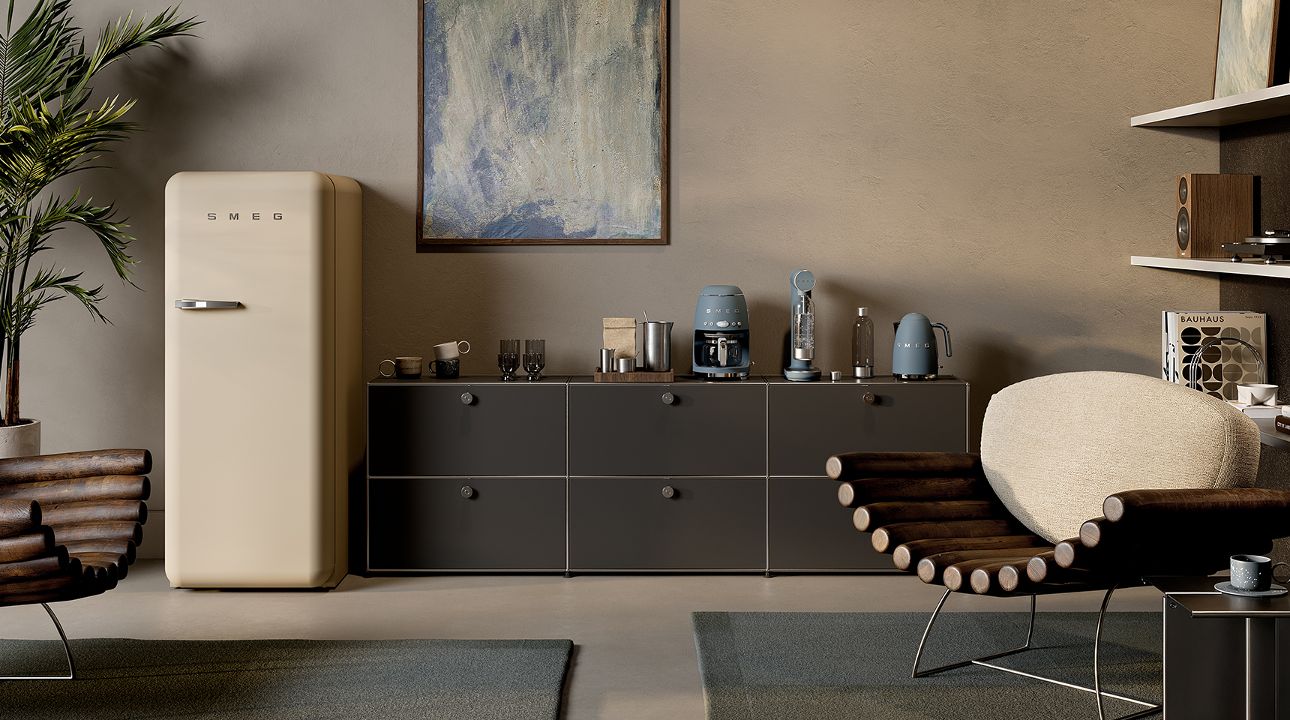 Stylish living space featuring SMEG appliances in moonlight matt finish, including small countertop appliances arranged on a dark sideboard, paired with a retro-style refrigerator, warm neutral walls, wooden furniture, and soft natural textures.