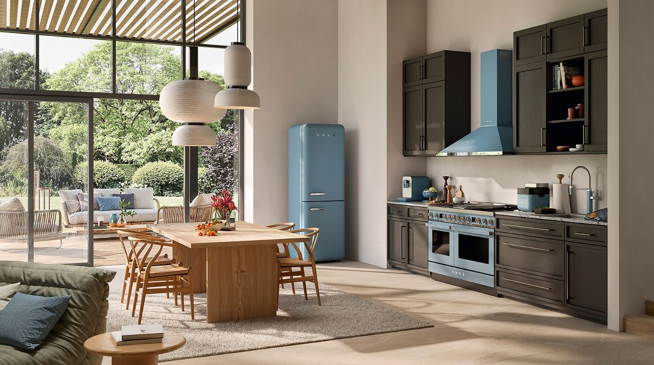 Contemporary coffee corner with a matt black soda maker and a drip filter coffee machine in moonlight matt finish, placed on a curved counter in a stylish interior featuring a “COFFEE ROOM” sign, shelves, plants, and warm terracotta-toned walls.