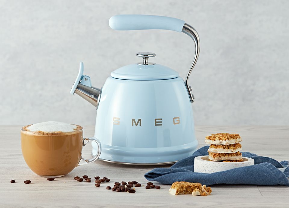 Teal Tea Kettle Boiling Hot Water On Top Of A Black Stove Top