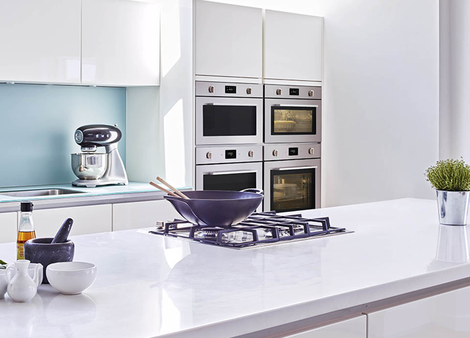 A bright modern kitchen, with 4 stainless steel integrated ovens