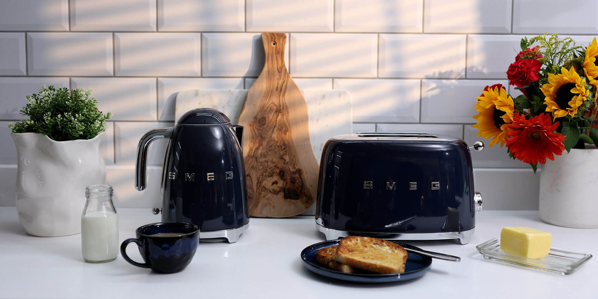 Smeg Navy Blue kettle and toaster set on a kitchen countertop