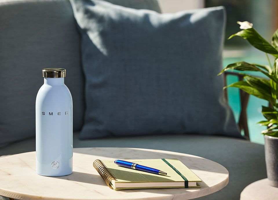 Pastel blue Smeg water bottle on table