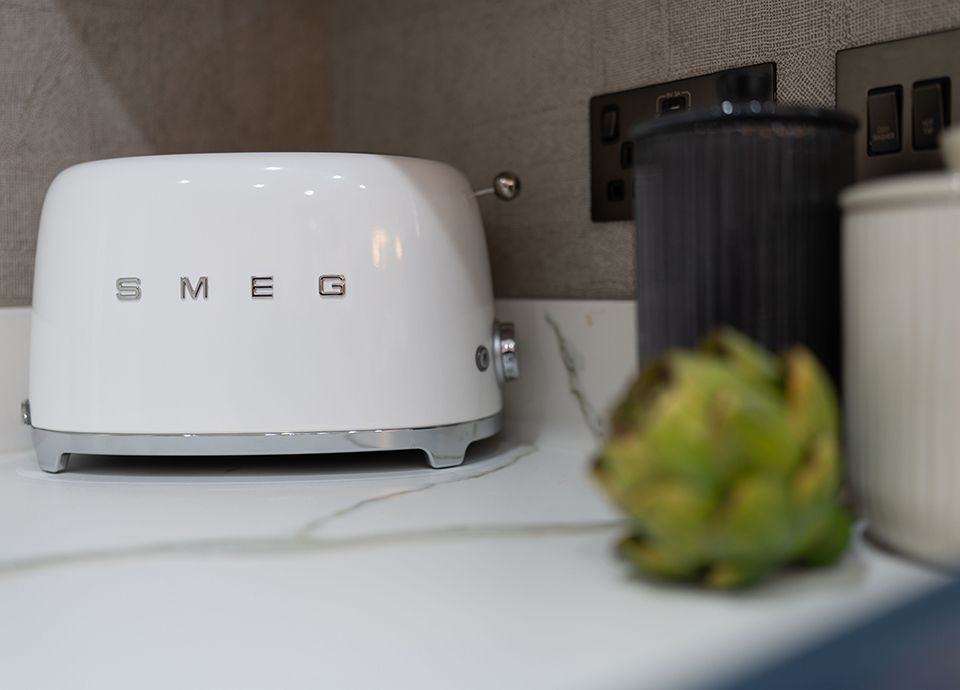 Smeg white toaster on light coloured countertop