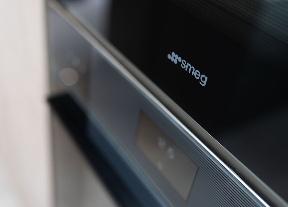 Modern new build kitchen with oven doors open