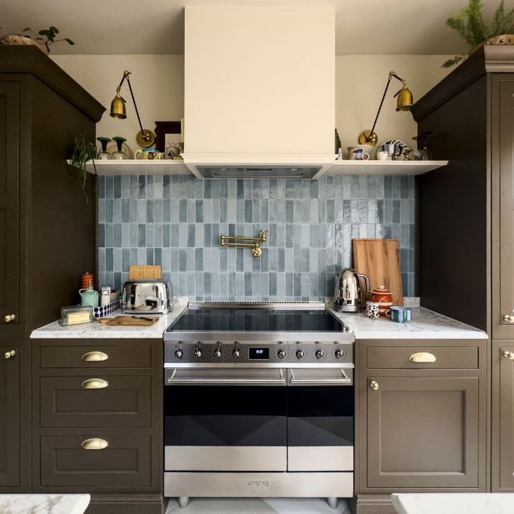 Smeg stainless steel range cooker slotted in to dark kitchen units
