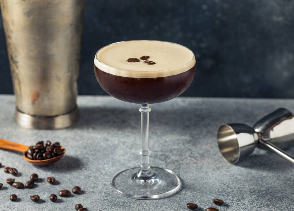 Espresso Martini Cocktail served in a martini glass with a creamy froth, garnished with 3 coffee beans.