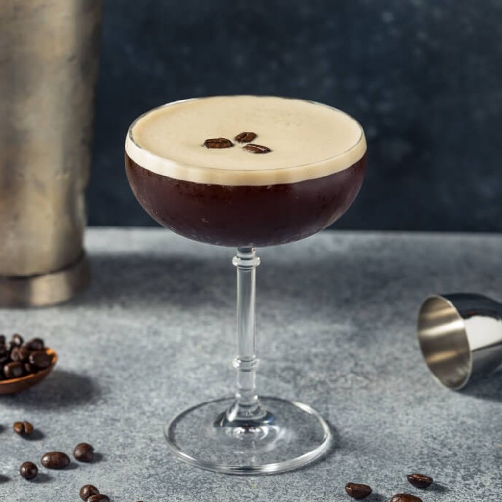 Espresso Martini Cocktail served in a martini glass with a creamy froth, garnished with 3 coffee beans.
