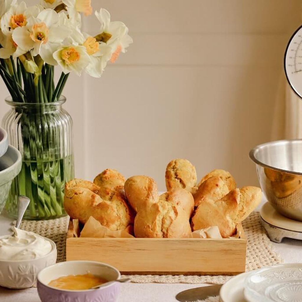 Lemon Easter bunny-shaped scones served warm with lemon curd and whipped cream
