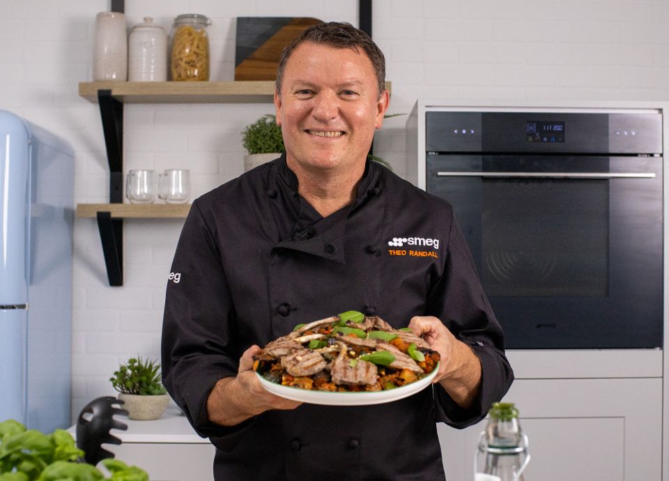 Theo Randall holding Caponata with grilled lamb chops