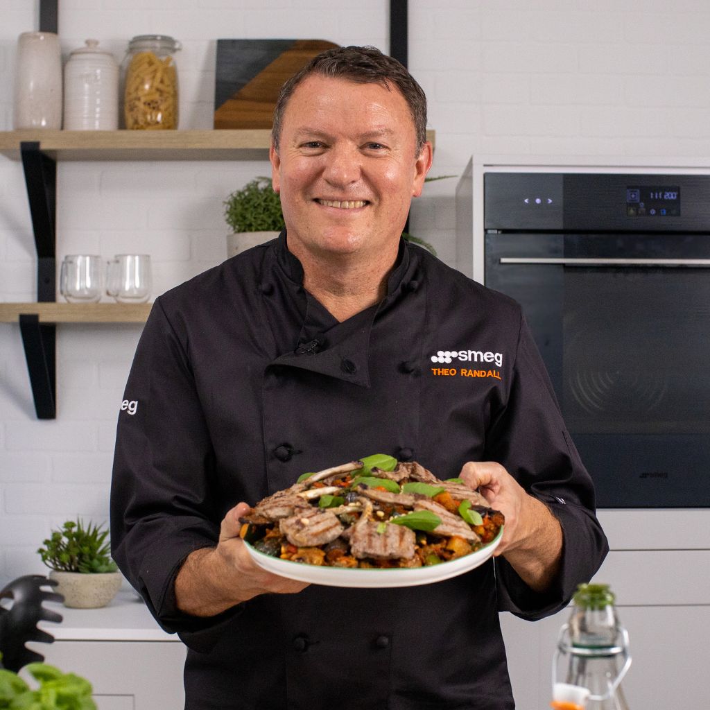 Theo Randall holding Caponata with grilled lamb chops
