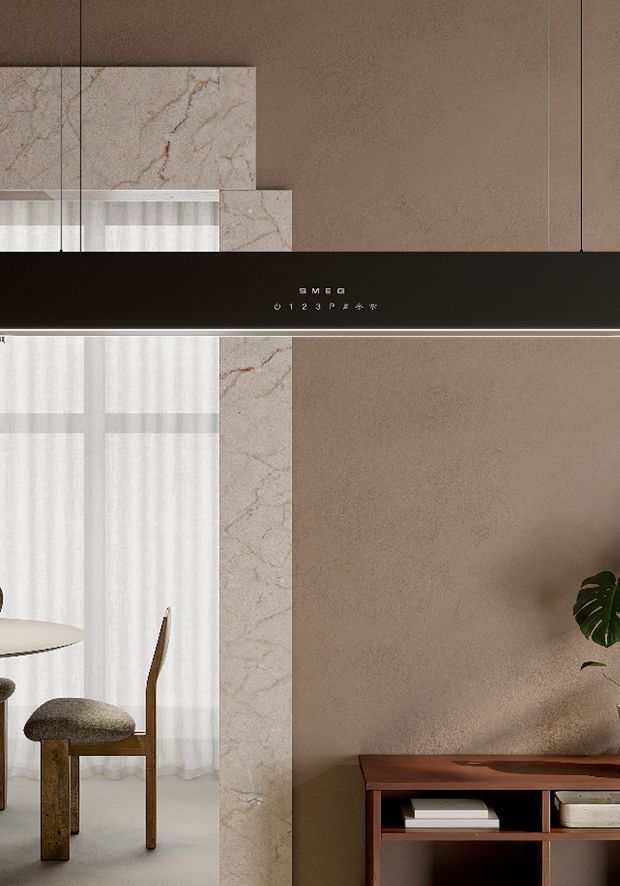 Black suspended  hood with a minimalist profile and integrated touch controls, hanging over a dining area with warm neutral decor.