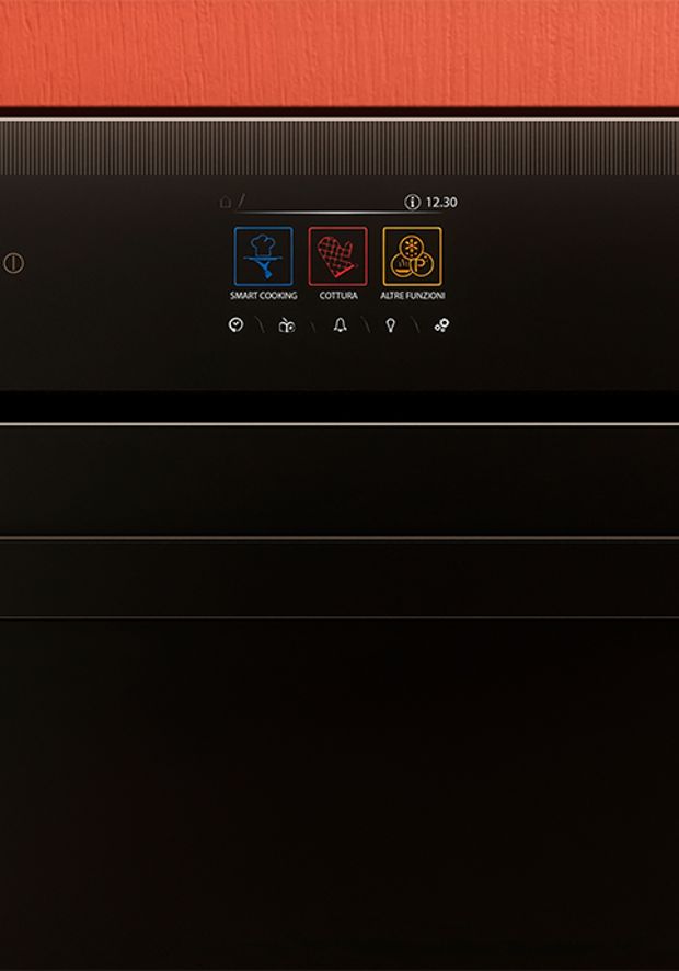 Close up of a black induction hob on a marble kitchen countertop