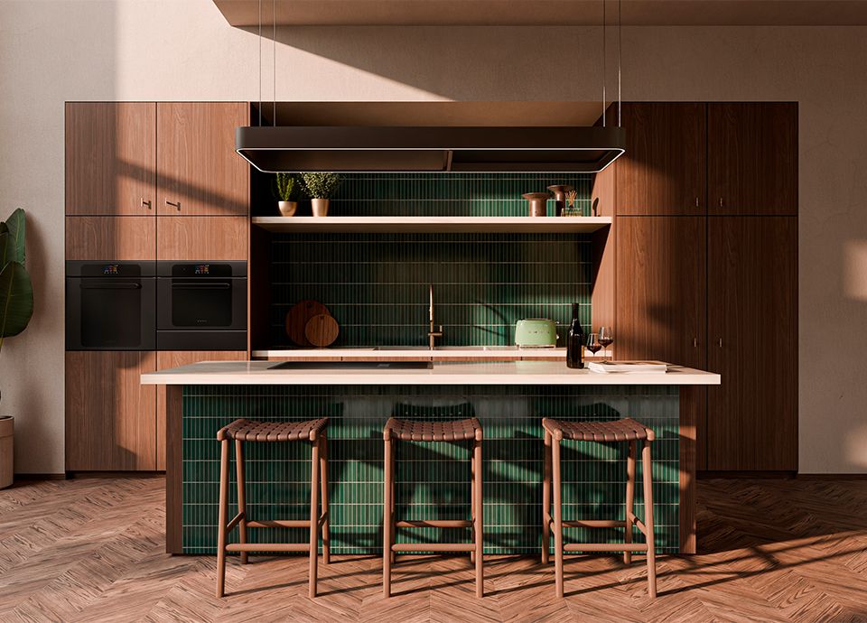 A kitchen featuring wood cabinets, black built-in ovens, and a white marble island with green vertical tiles and woven leather stools.
