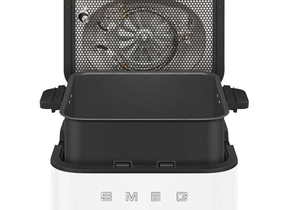 Smeg air fryer with open lid and removable basket showing internal heating element