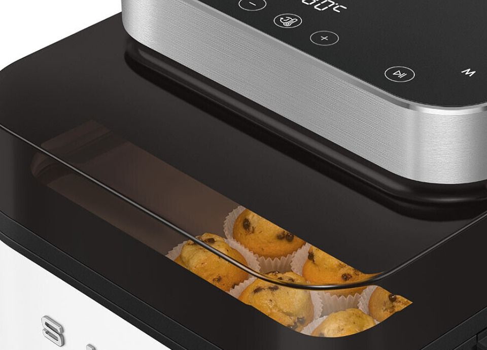Close-up of Smeg air fryer see-through window showing muffins baking inside