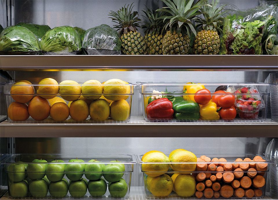 Smeg refrigerated cabinet with arranged fruit containers on shelves