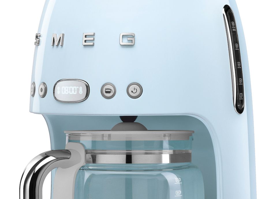 Close-up of a pastel blue drip filter coffee machine's transparent water level indicator with liter and cup markings.