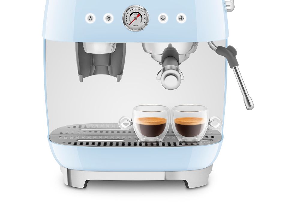 Pastel blue Smeg manual espresso coffee machine brewing two espressos, featuring dual thermoblock system and steam wand