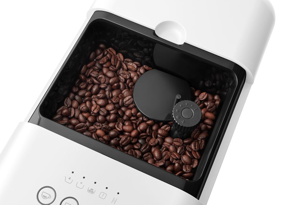 Top view of coffee beans inside a Smeg coffee machine bean hopper with integrated grinder mechanism