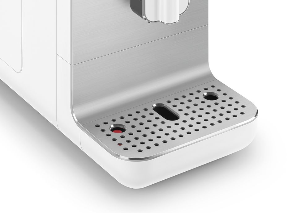 Close-up of Smeg coffee machine drip tray in stainless steel with perforated surface and removable drip indicator