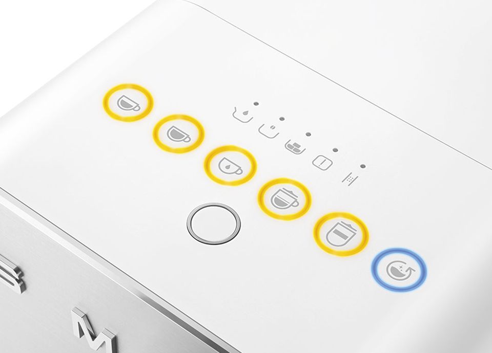 Close-up of Smeg coffee machine control panel with illuminated beverage selection icons and power button highlighted