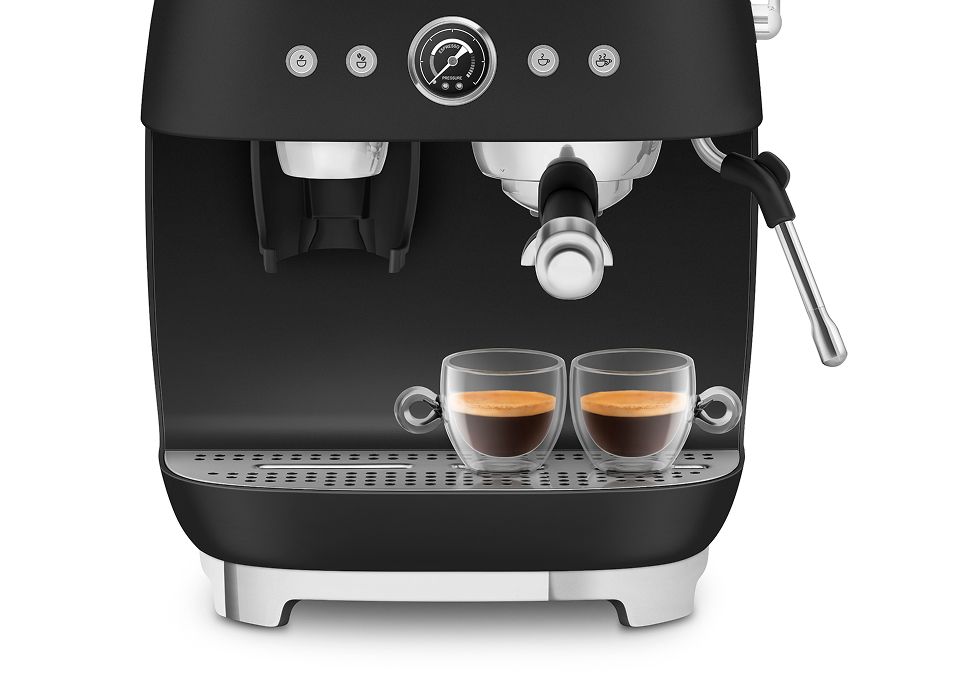 Matt black Smeg manual espresso coffee machine brewing two espressos, featuring dual thermoblock system and steam wand