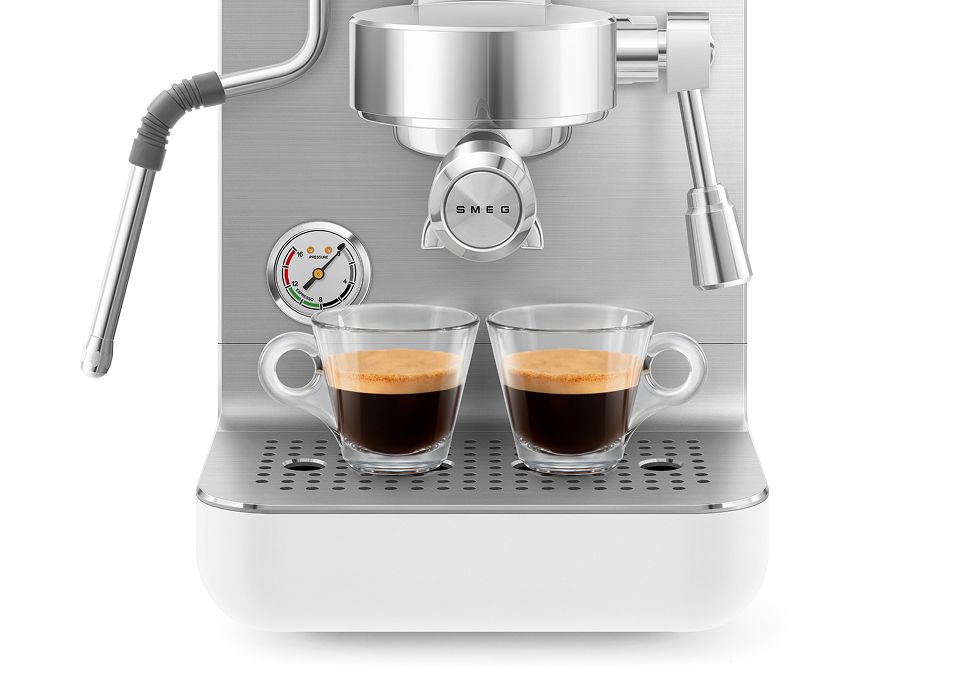 Stainless steel mini professional coffee machine preparing two espressos with dual spouts, pressure gauge, steam wand, and drip tray