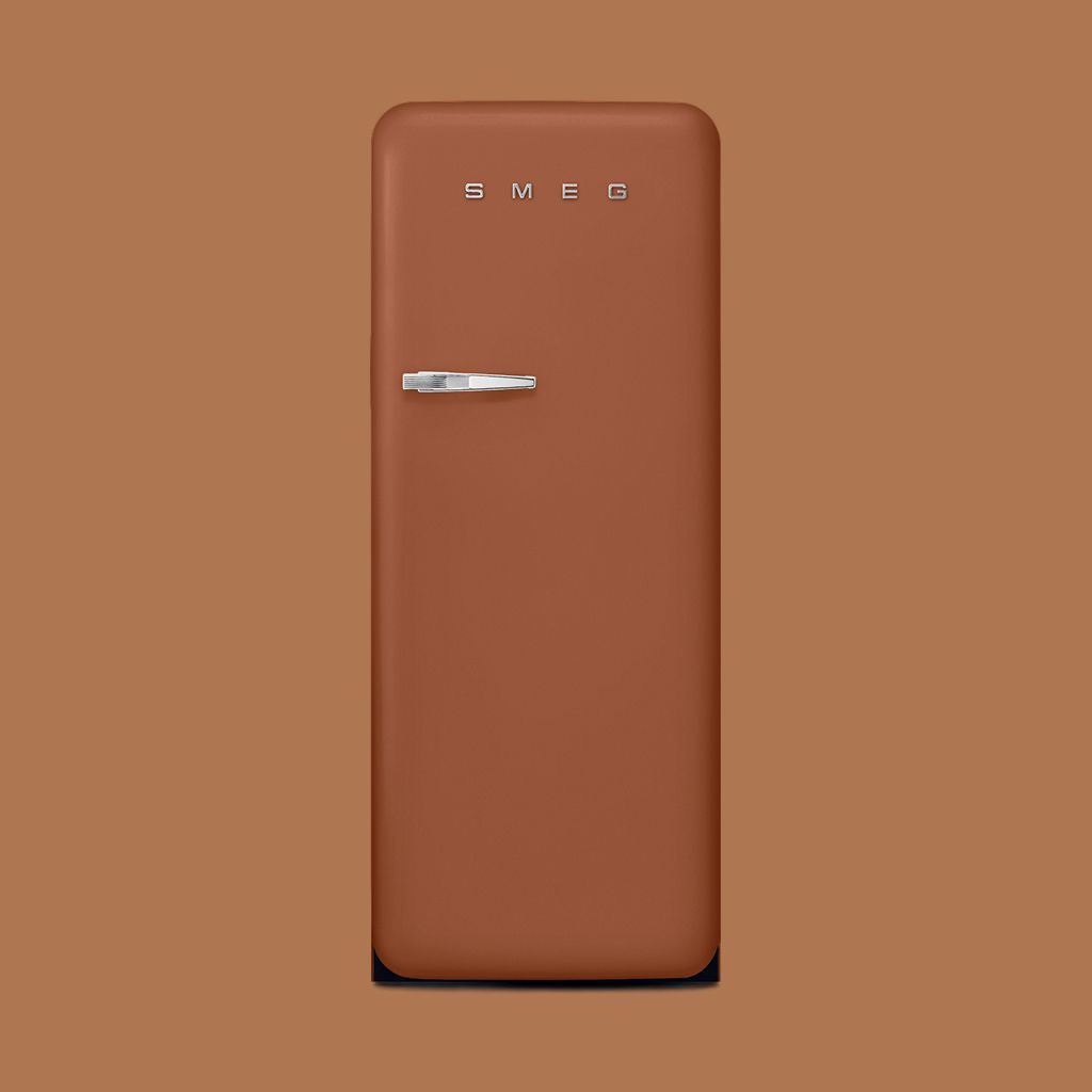 A cream, retro-style Smeg refrigerator with a silver handle against a minimalist neutral wall.