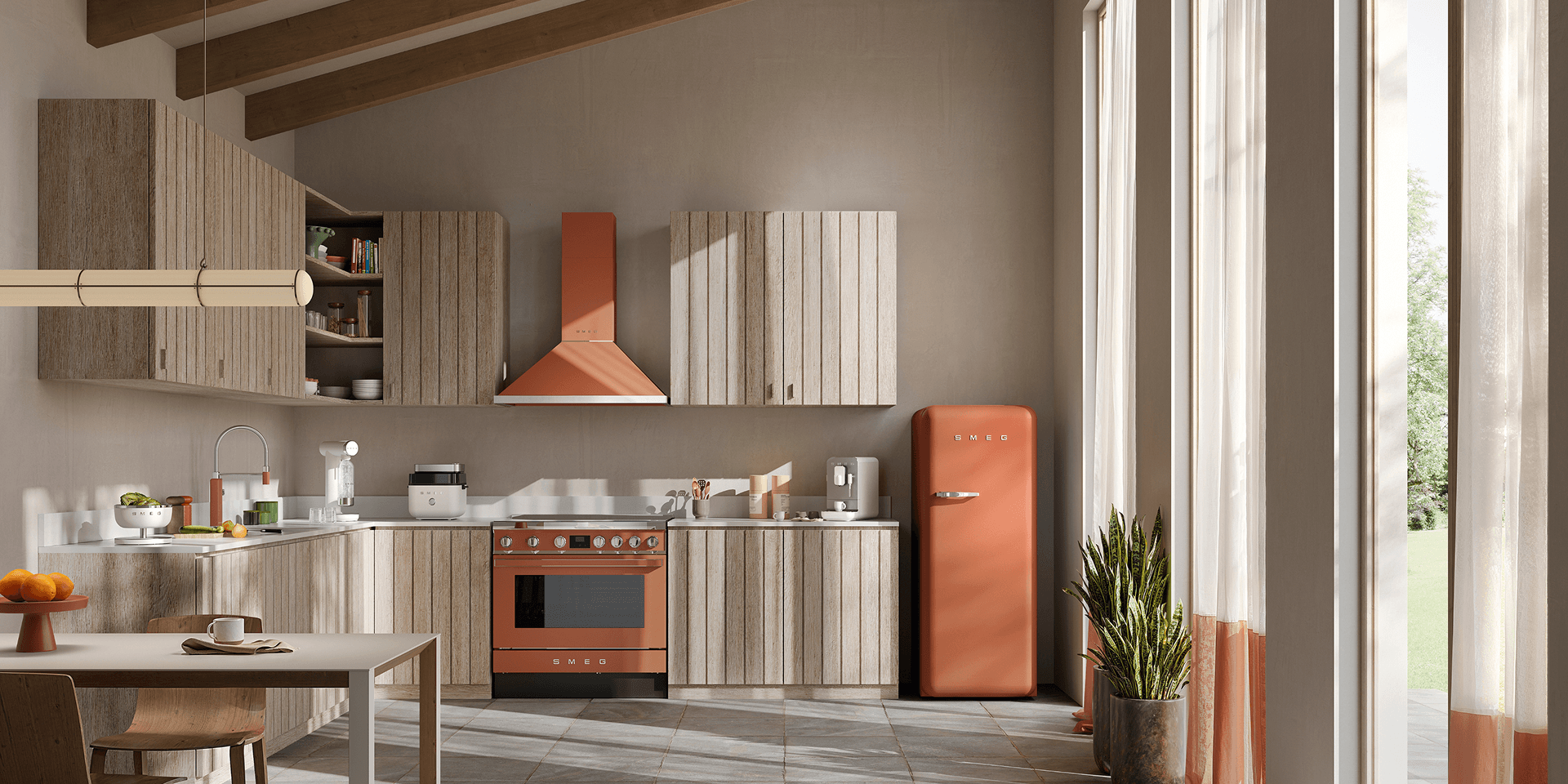 Minimalist kitchen with SMEG appliances in amber clay finish, including a range cooker, extractor hood, and retro-style refrigerator, set against light wood cabinetry, soft neutral walls, and natural light from a large window.