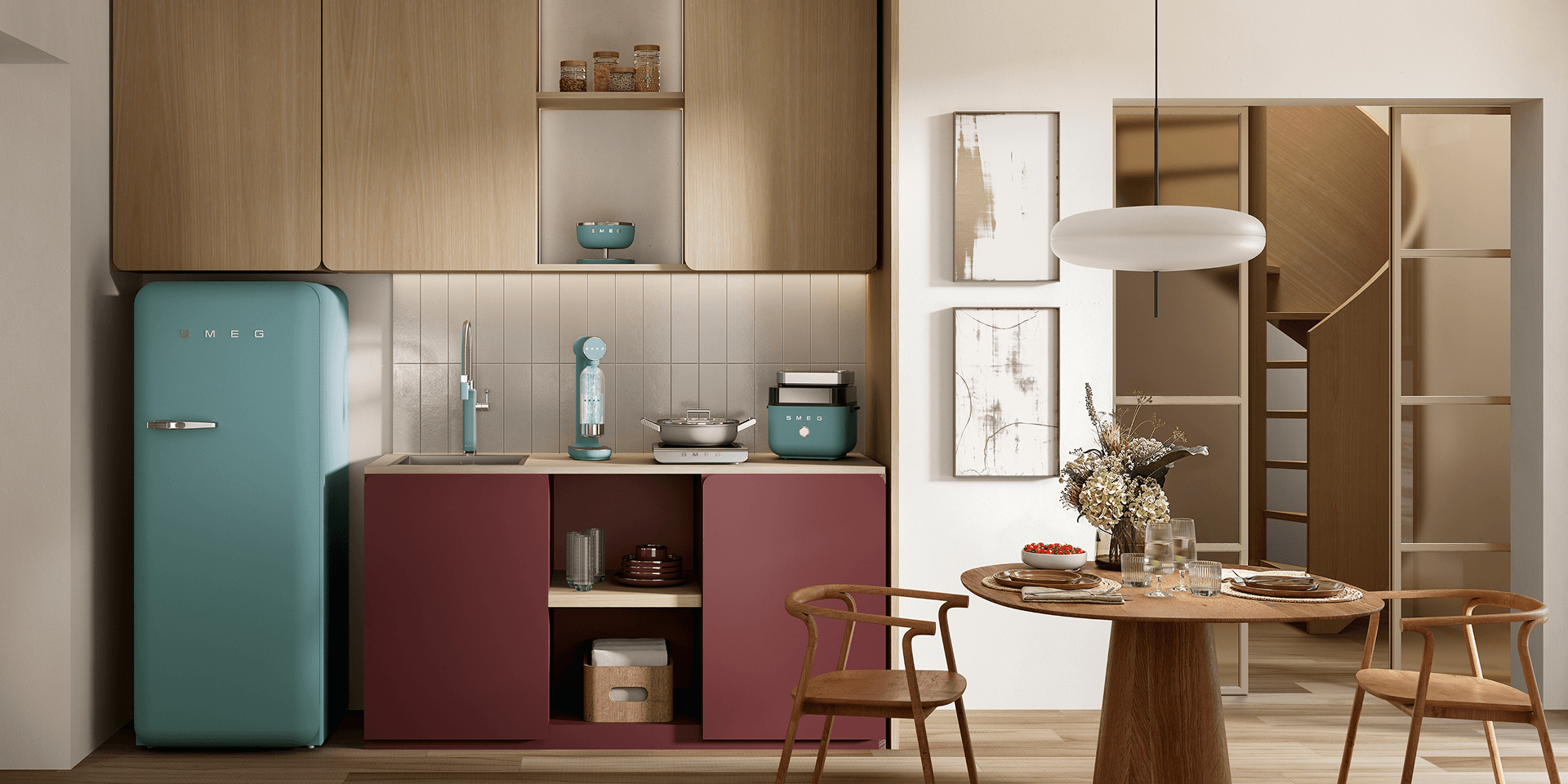Compact kitchen corner featuring SMEG appliances in emerald green finish, including a retro-style refrigerator, soda maker, and small countertop appliances, set against warm wood cabinetry and burgundy lower units with a dining area to the side.