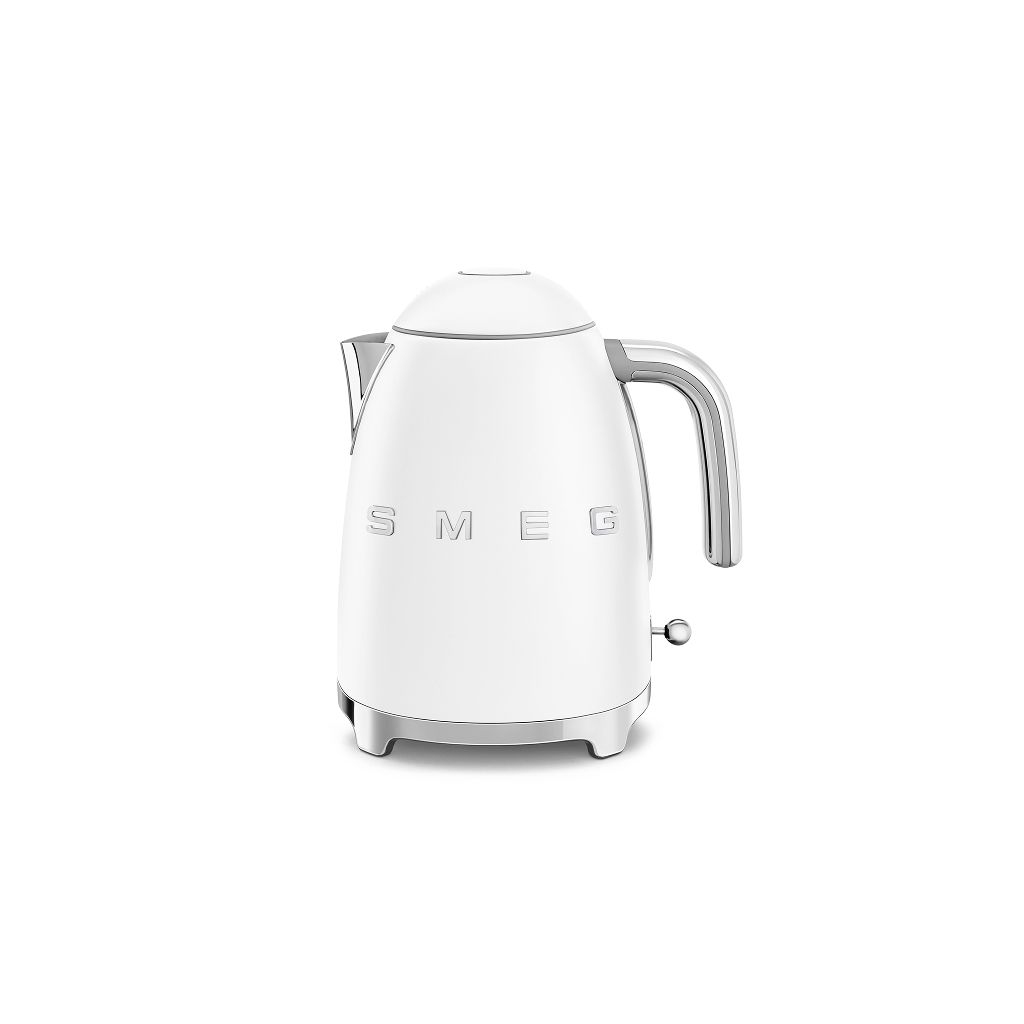 A cream retro Smeg coffee machine with a glass carafe sits on a stone plinth against a soft neutral background.