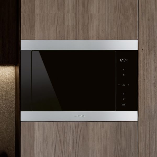 SMEG built-in microwave oven set in a black setting.