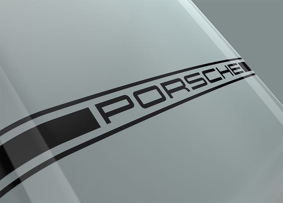 Detail of the front lower part of the refrigerator FAB in colour shade green. Near the bottom, a horizontal black band features the word "PORSCHE" in black uppercase letters.