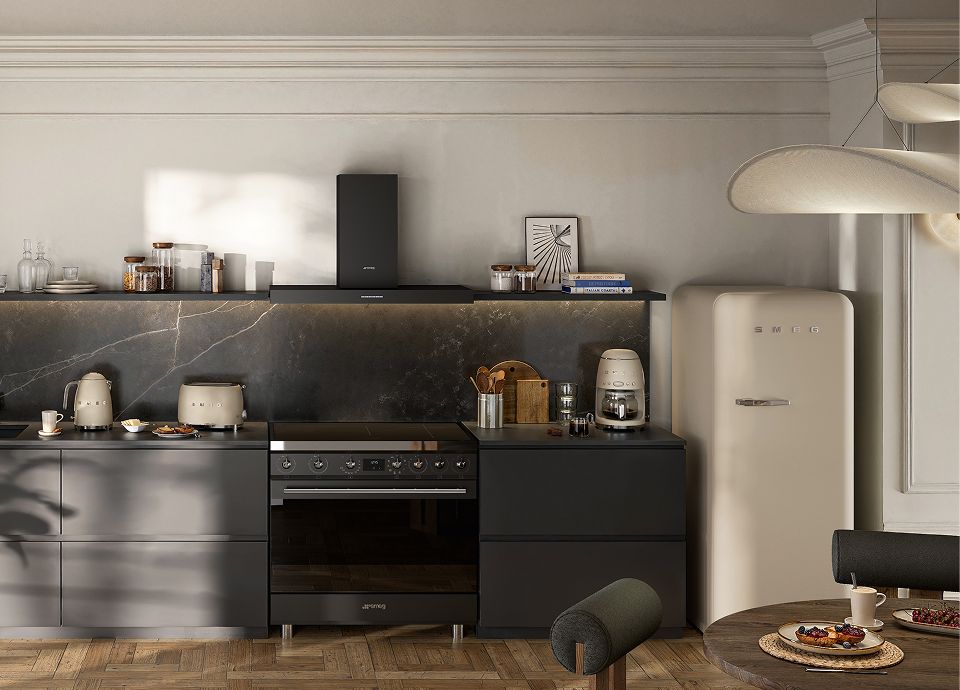 Modern kitchen with Moonlight Matt-finish appliances, including a refrigerator, coffee machine and toaster, set against dark cabinetry and a stone backsplash.