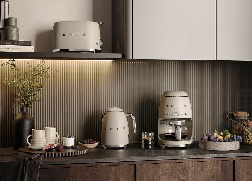 Moonlight Matt-finish coffee machine, kettle and toaster in a modern kitchen with dark cabinetry and a ribbed backsplash.
